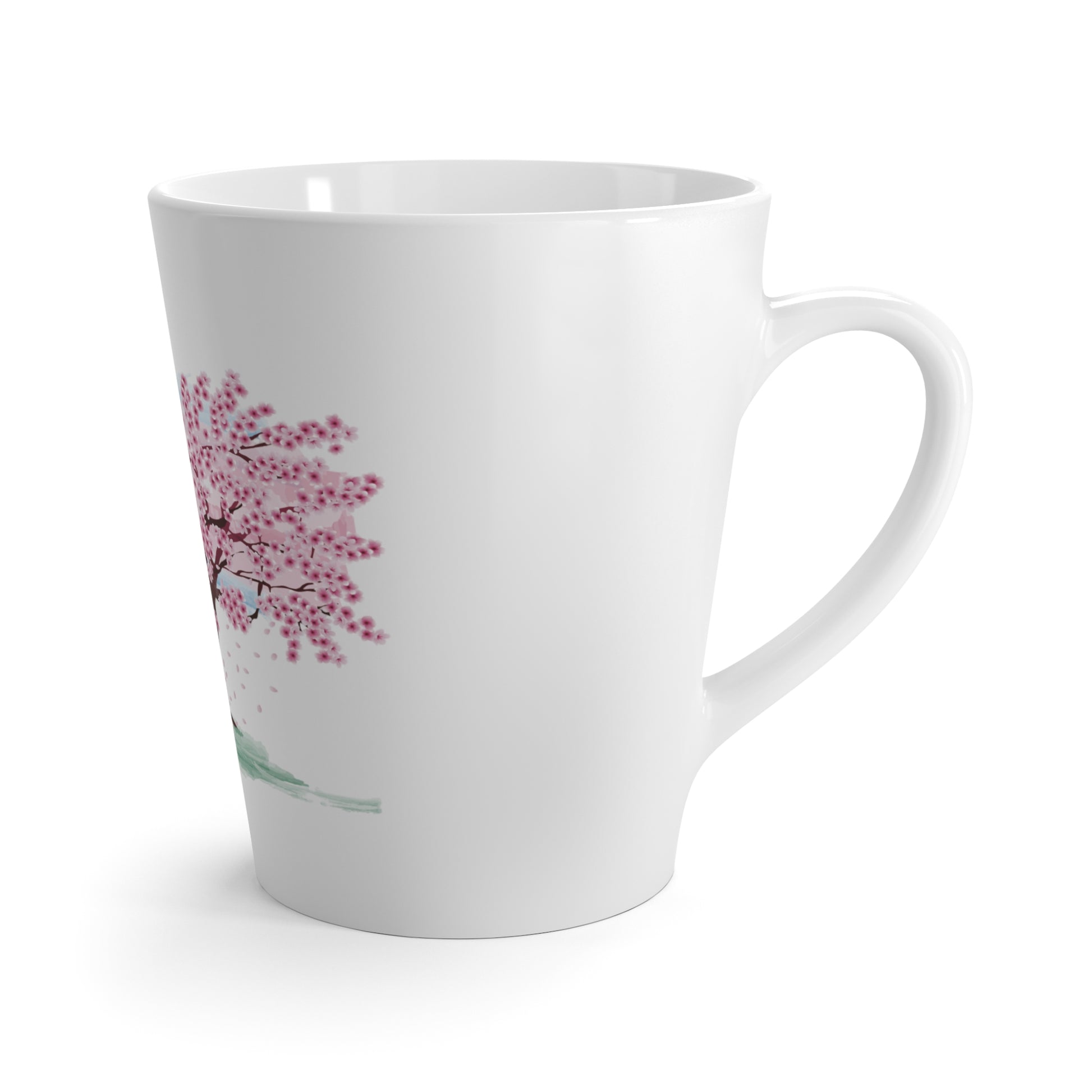A white latte mug with a pink blossoming tree design with white  background.