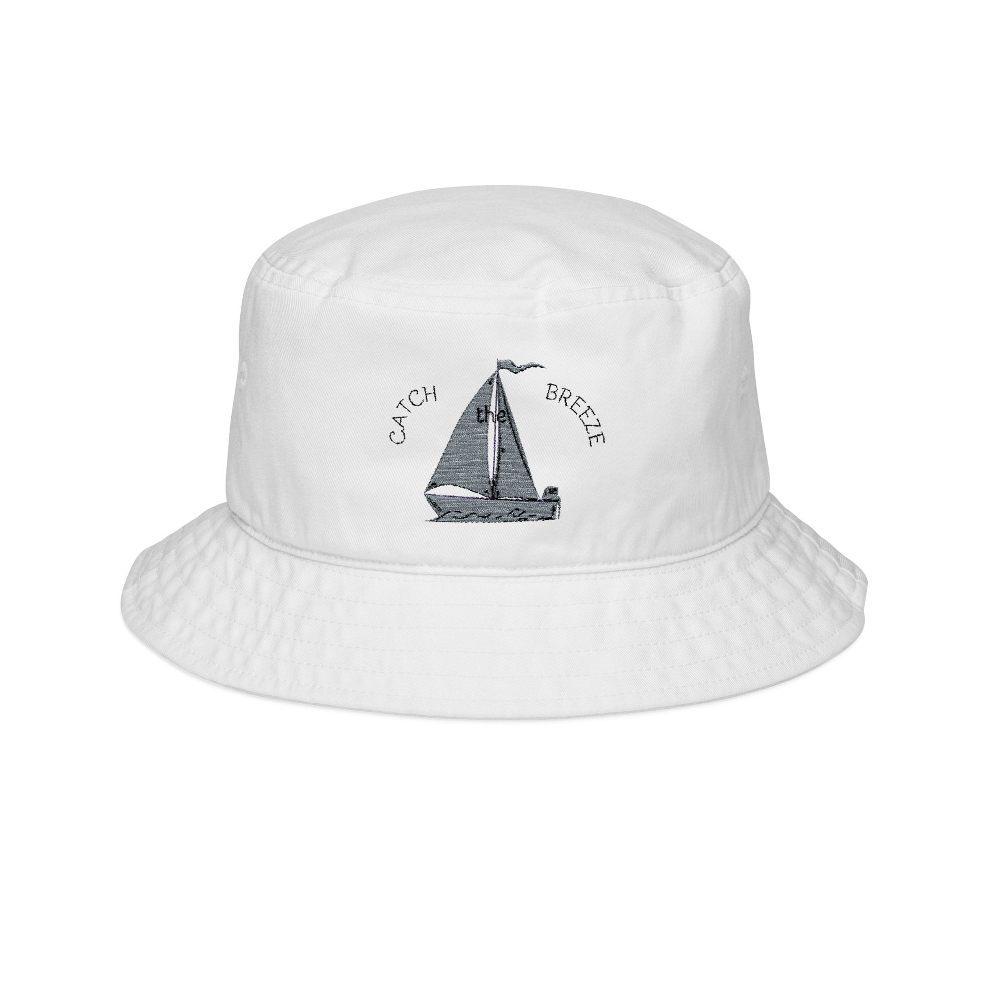 White bucket hat with sailboat design and 'Catch Breeze' text on a white background