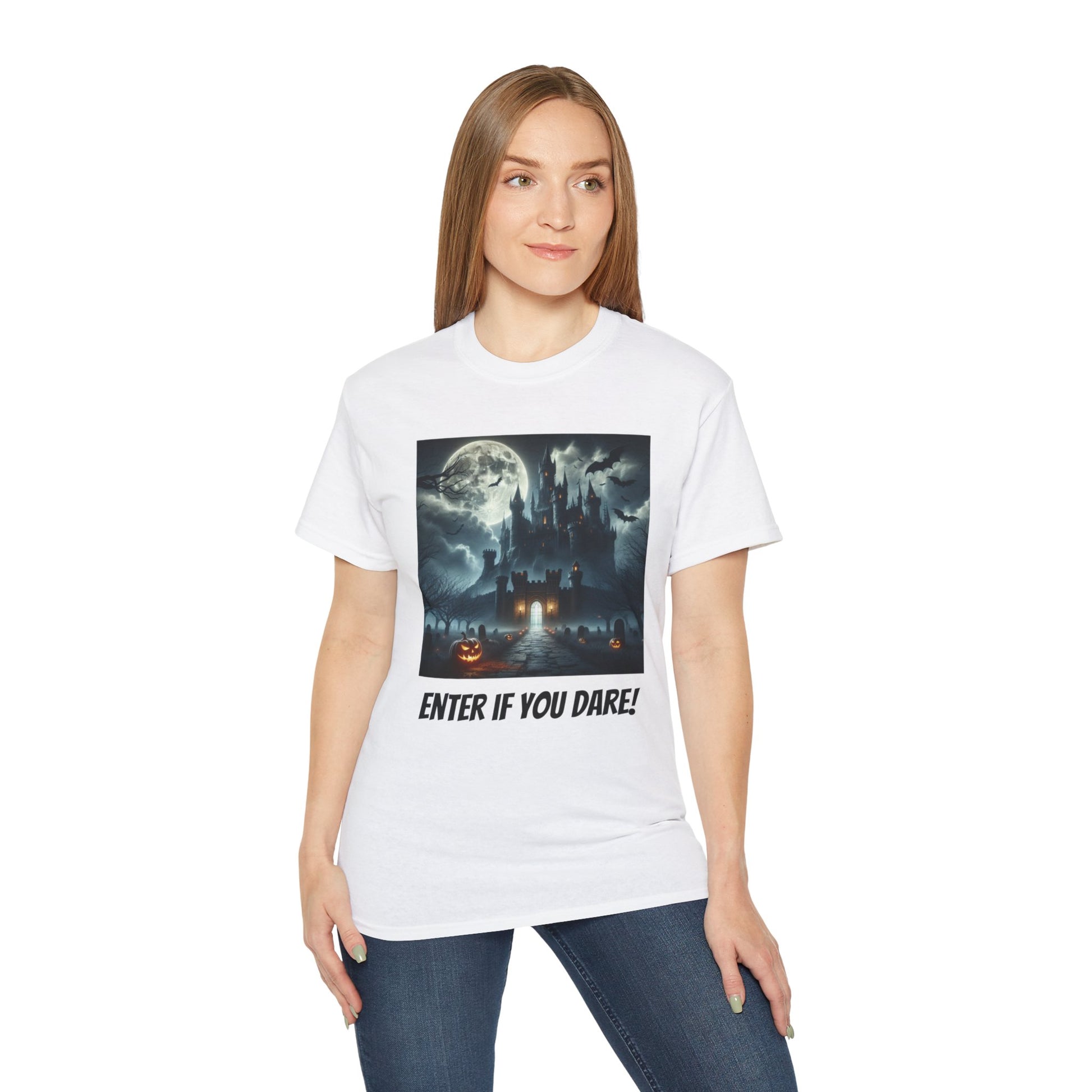 A woman wearing a white t-shirt, a graphic of a haunted castle with a full moon, bats, and pumpkins, text 'ENTER IF YOU DARE!', dark blue and black colors, white fabric texture, graphic design elements.