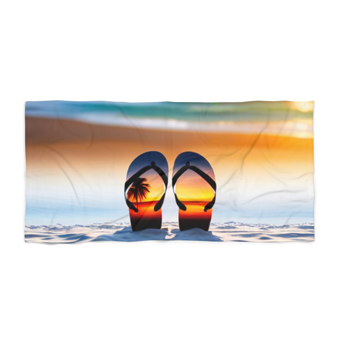 A beach towel featuring a flip flop design with a sunset background.