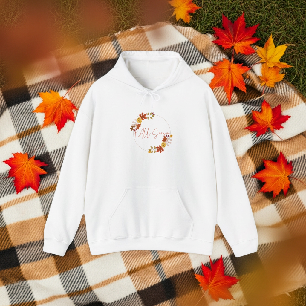 White hoodie with 'All Season' text and leaf design on a plaid fabric background with autumn leaves.