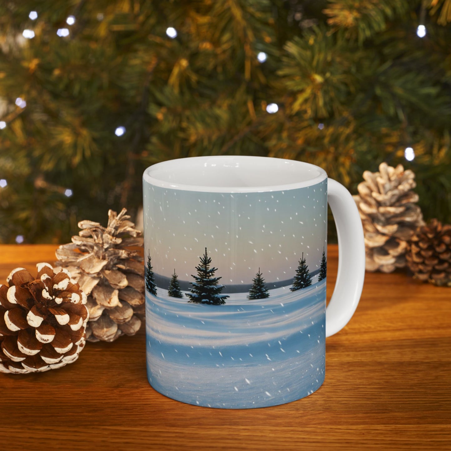 Mug with winter scene design in front of a Christmas tree and pinecones
