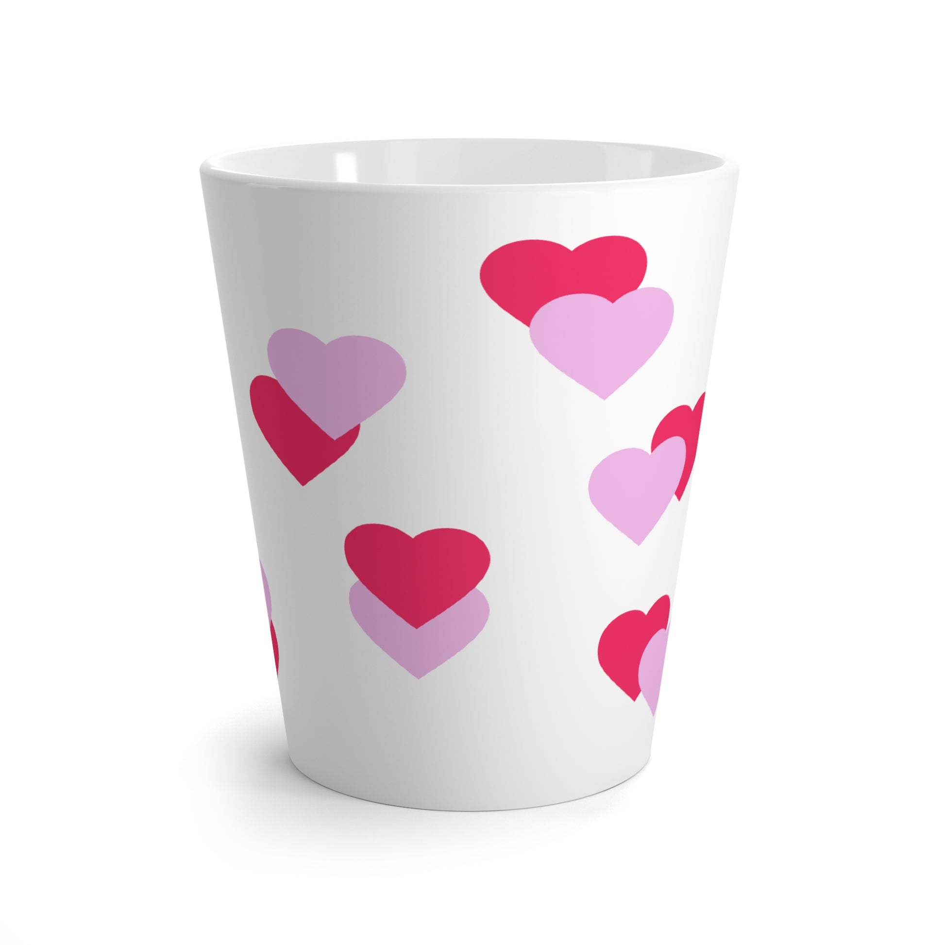 White cup with pink and red heart patterns on a white background