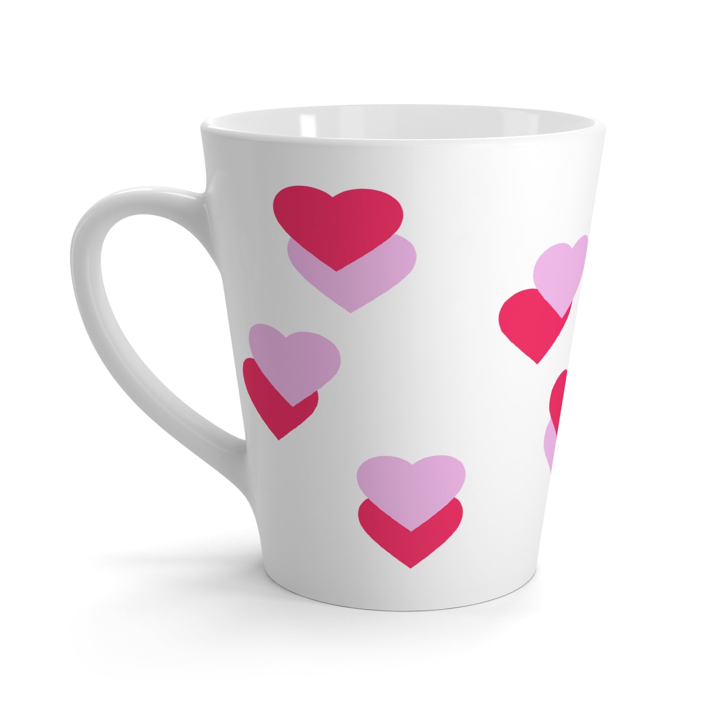 White mug with pink and purple heart patterns on a white background