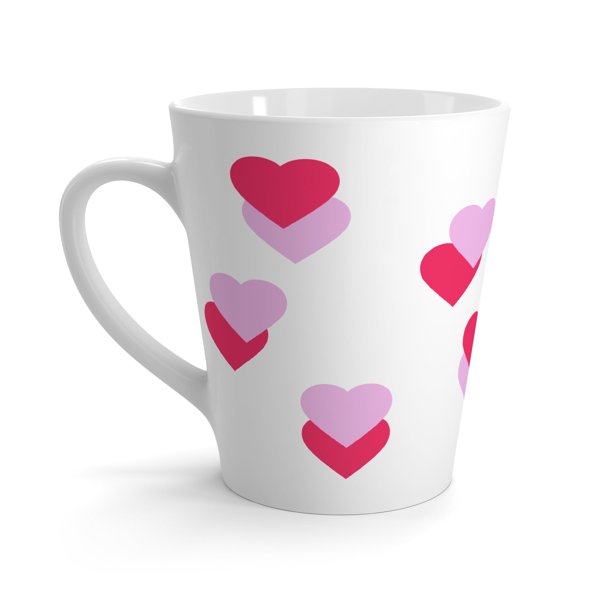 White mug with pink and purple heart patterns on a white background