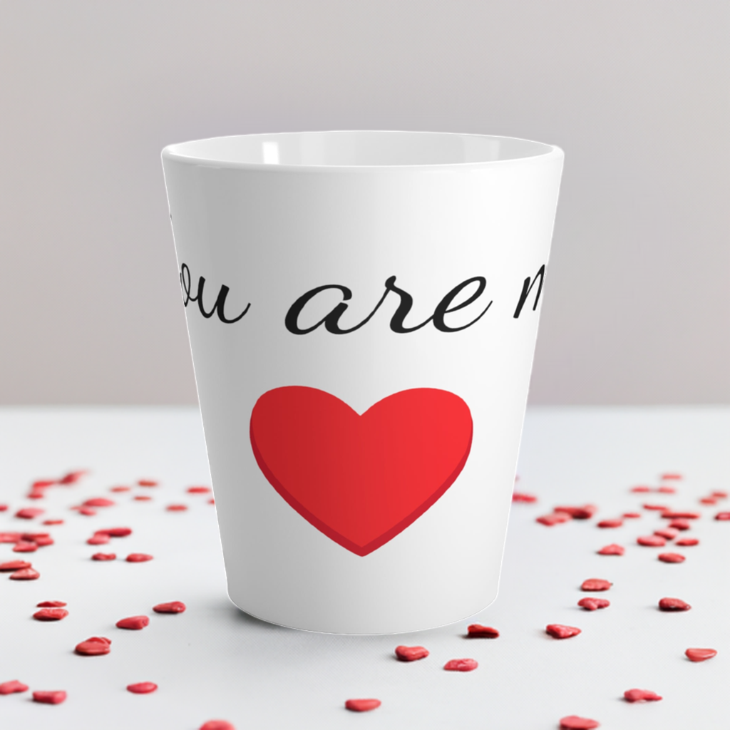 This is a coffee mug that says: You are my heart. There are small hearts scattered around the mug on the table